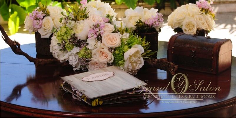 wedding guest book on table with flowers and box