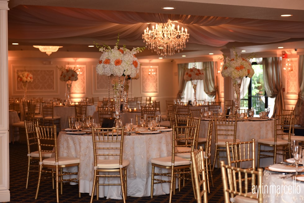 Table set up flowers gold chairs chandelier