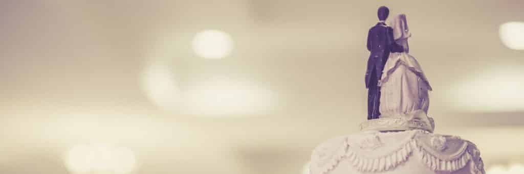 rear-view-of-wedding-cake-with-blurry-venue-in-background