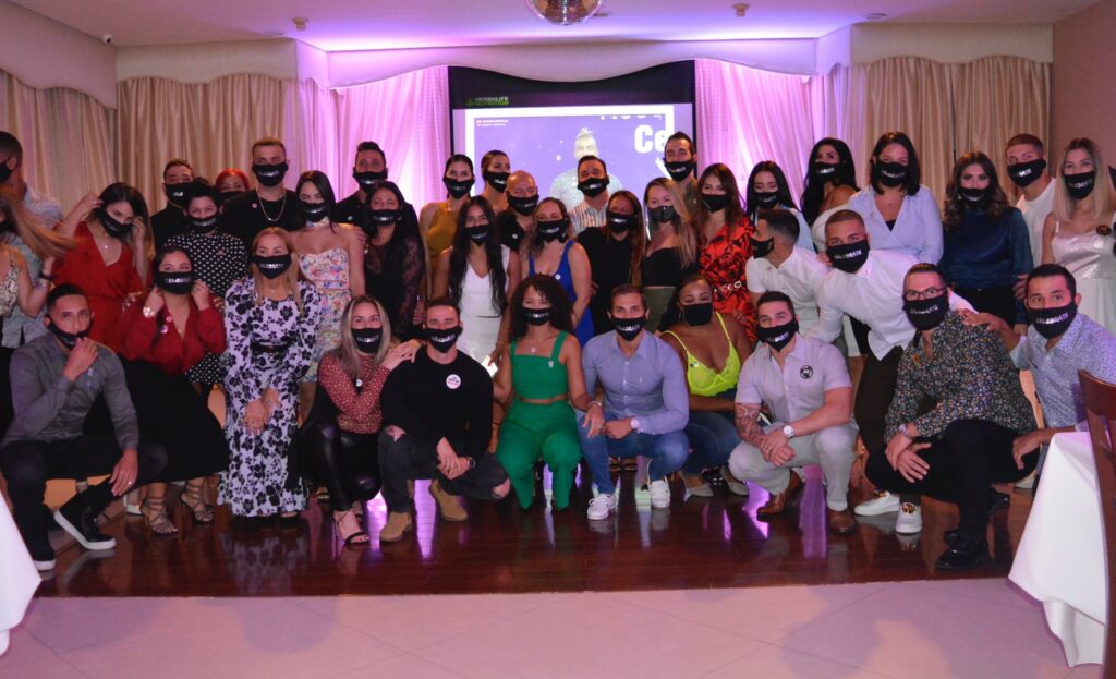 A group of coworkers smiling at a business dinner event