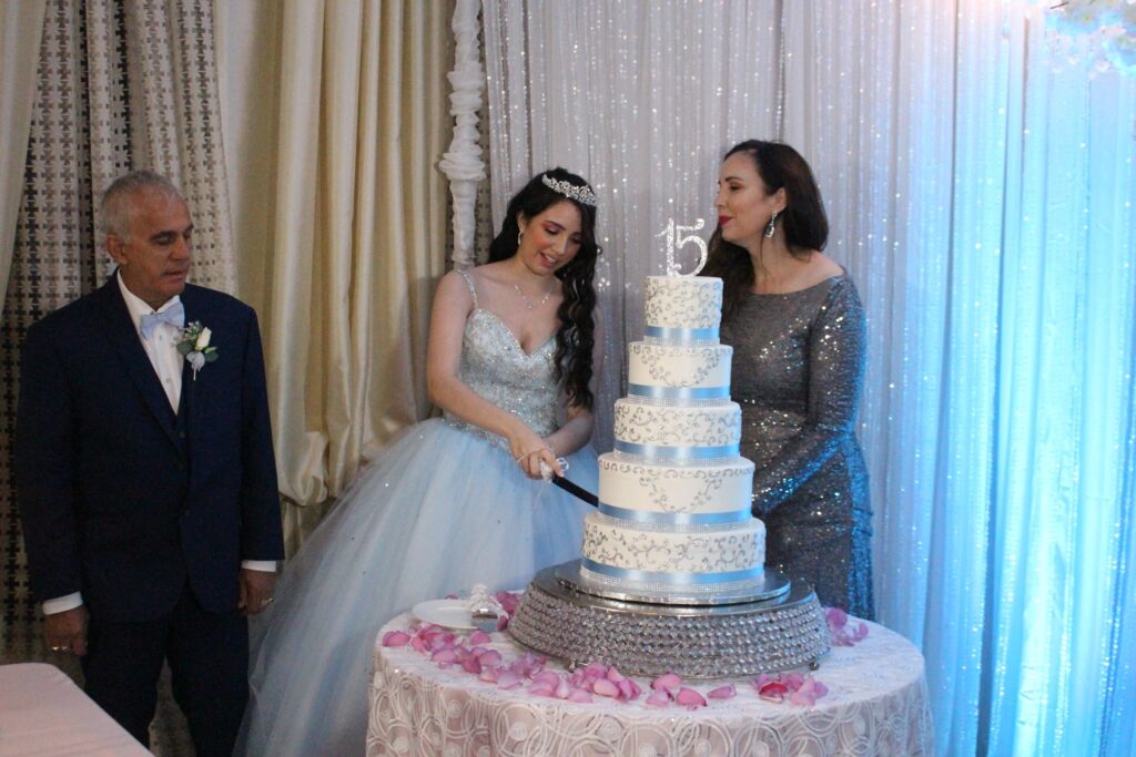 A birthday girl cutting a cake at her party