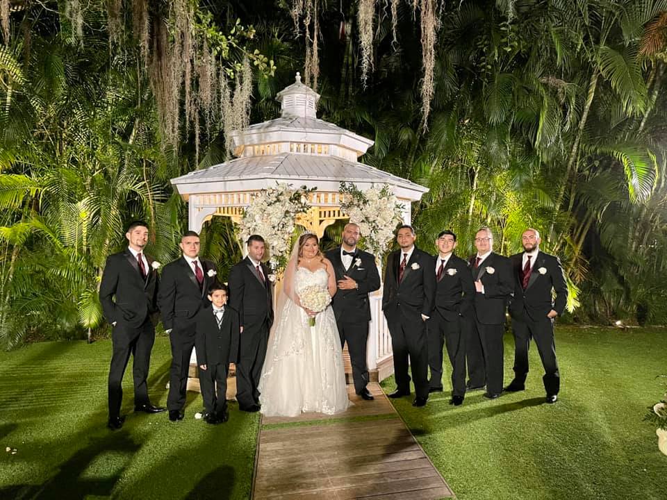 A wedding couple surrounded by groomsmen