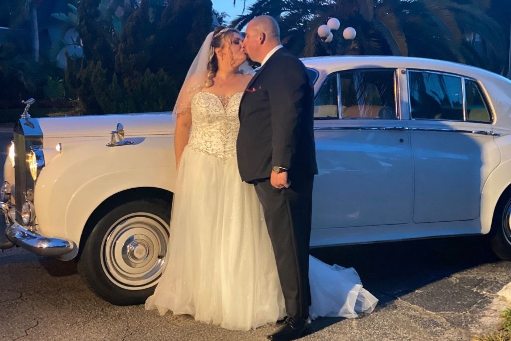 A wedding bride and groom sharing a kiss at their wedding