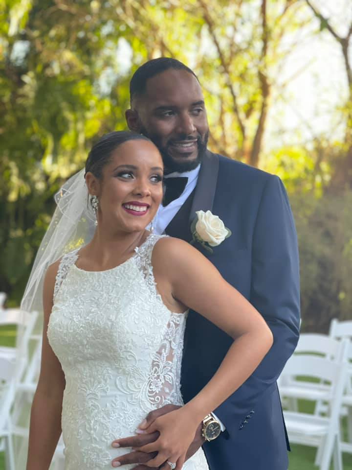 Tiffany and Christian cuddling while posing for wedding photo