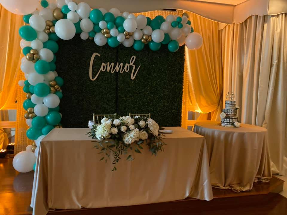 A Black Sign Saying 039 Connor 039 Surrounded By White And Green Balloons | Welcoming Baby Connor Into The World | Real Events