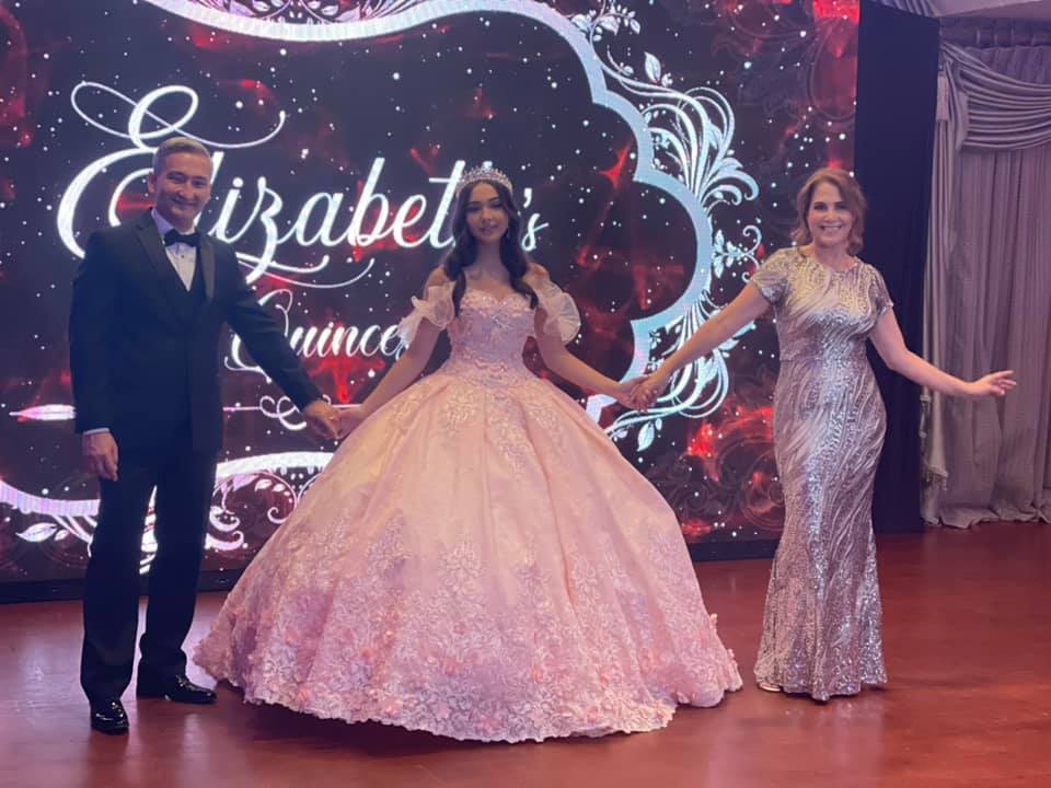 Elizabeth and her parents in her Quince dress with her name emblazoned in the background